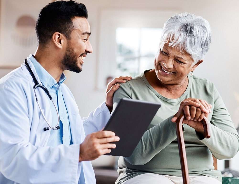 A dialysis patient speaking with a member of the care team