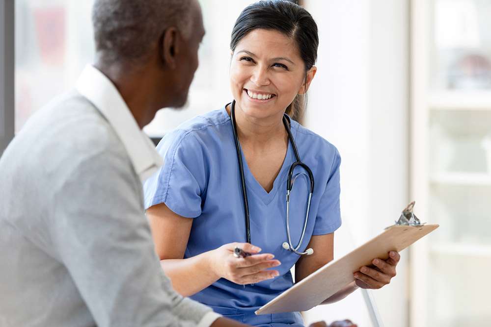 A clinician speaking with a dialysis patient